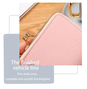 Close-up of pink litchi grain leather bag showing high-quality fine stitching and golden clasp