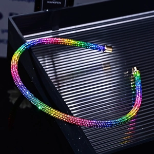 Macro shot of thin headband with rainbow gradient rhinestones and gold-plated end caps