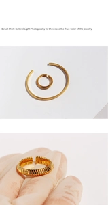 Detail view of gold snake bone textured open bangle and ring set with ribbed metal finish
