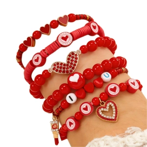 Set de pulseras rojas con cuentas y dijes de corazón I y U en la muñeca para San Valentín