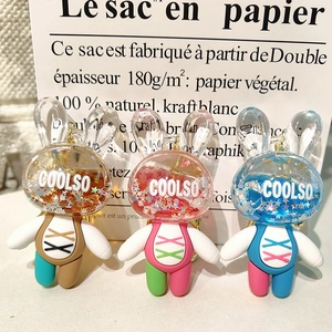 Detailed trio of colorful bunny keychains with sparkling liquid sequins in acrylic heads