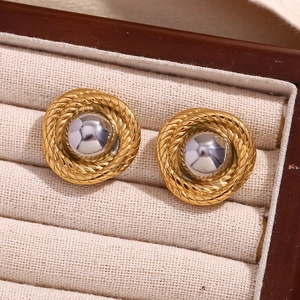 Detail of two-tone braided round stud earrings with gold finish and metallic center