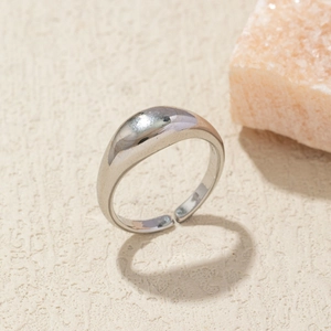 Macro view of bright silver adjustable open ring with a smooth polished arched surface