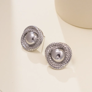 Detailed macro view of silver twisted rope textured round stud earrings in stainless steel