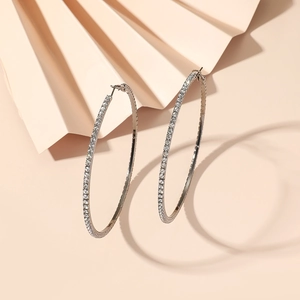 Macro shot of silver oversized hoop earrings with pavé set cubic zirconia crystals