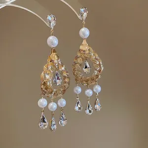 Vintage hollow gold drop earrings with white pearls and sparkling crystal pendants