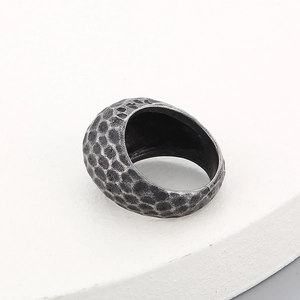 Close-up of vintage hammered texture on silver men's titanium steel cylinder ring