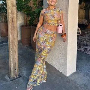 Detail of floral lace mesh crop top and maxi skirt set with vibrant flower patterns