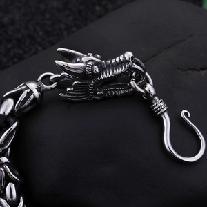 Detailed close-up of retro dragon head carving and scale texture on punk steel bracelet
