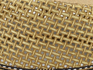 Close-up of summer straw hat showing cross-weave texture and black decorative ribbon