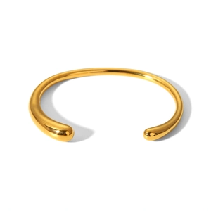 Macro detail of gold-plated stainless steel cuff bracelet with teardrop ends and mirror finish