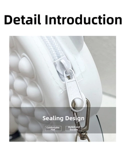 Detail view of the silver zipper closure on a white silicone pop-it shoulder bag