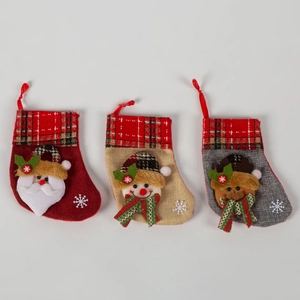 Three Christmas stockings with Santa, Snowman, and Reindeer designs and plaid cuffs