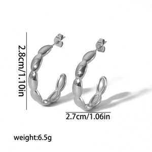 Irregular C-shaped stainless steel earrings with textured bead pattern in silver finish