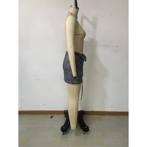 Detail of dark gray washed mini skirt featuring side zipper and lace-up drawstring design