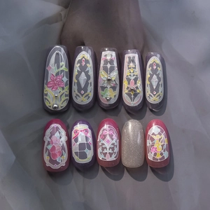 Detailed view of handmade Rococo style press-on nails with colorful stained glass patterns