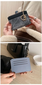Detail of mini leather card holder with card slots, zipper pouch and gold keychain