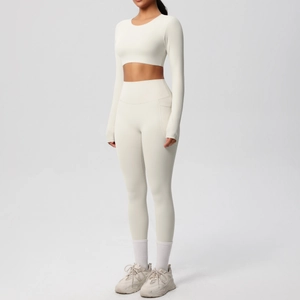 Detail of cream yoga set showing long sleeve crop top and high-waisted leggings with side pocket
