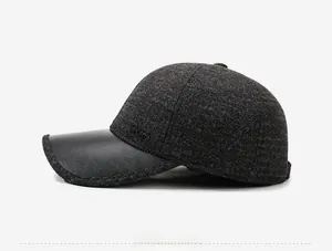 Side view of men's winter baseball cap with grey wool fabric and leather brim
