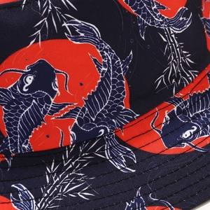 Detail of navy bucket hat featuring koi fish print and reinforced stitching lines