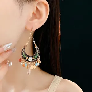 Bohemian crescent moon earrings with green enamel and colorful beaded tassels