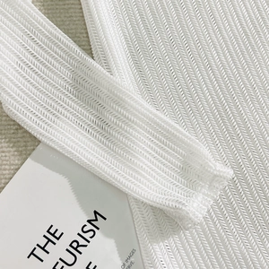 Close-up detail of white mesh fabric with diagonal woven texture for 3-piece bikini set