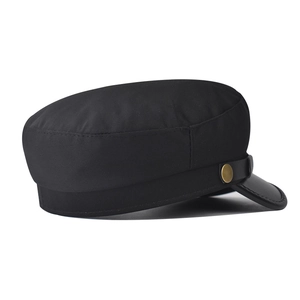 Detail shot of black newsboy hat featuring textured fabric and antique bronze metal buckle