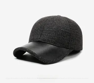 Side view of winter baseball cap featuring dark grey wool fabric and black leather brim