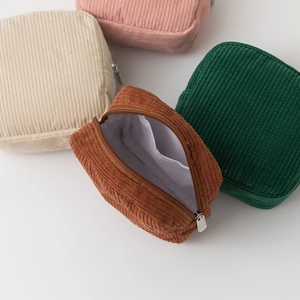 Close-up of corduroy cosmetic pouch showing soft texture and white interior lining