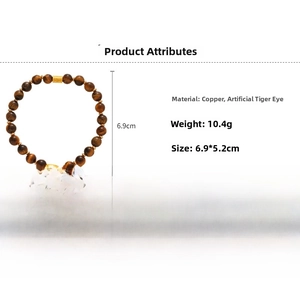 Detail view of tiger eye beaded bracelet with gold copper accents and product dimensions
