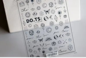 Macro detail of TS-489 nail stickers featuring black sun, moon, and mystic eye patterns