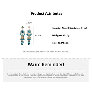 Detailed view of vintage bohemian earrings with blue crystals and measurement scale