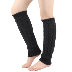 Detail of black cable knit leg warmers for women made from warm fleece-lined material