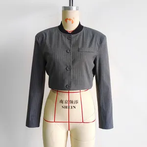 Detail of grey vertical striped cropped blazer jacket with a ribbed crew neck