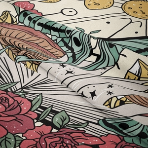 Detail of vintage bohemian tapestry fabric showing intricate rose and celestial patterns