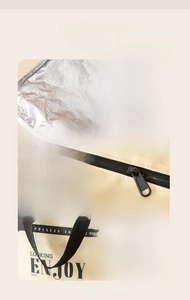 Detail view of thickened aluminum foil lining and sturdy handle on insulated lunch bag