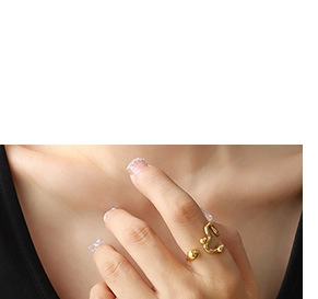 Detailed view of an irregular gold-plated heart pendant necklace worn by a model