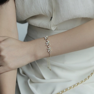 Close-up of elegant opal flower bracelet with zircon stones on female wrist