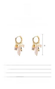 Macro detail of Baroque freshwater pearl earrings with gold S925 silver wire wrapping