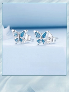 Close-up of S925 sterling silver butterfly stud earrings with blue gradient enamel details