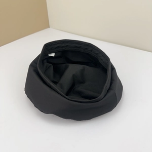 Inside view of black twill beret showing quality stitching and internal sizing label