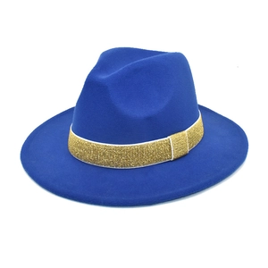 Detailed macro view of royal blue wool fedora hat with gold glitter ribbon decoration