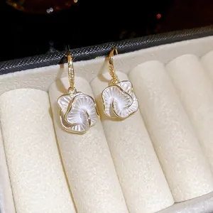 Exquisite gold-plated camellia flower drop earrings with sparkling zircon accents in a box