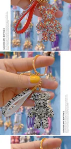 Detail view of crystal-encrusted bear keychain with leather strap and golden metal ring