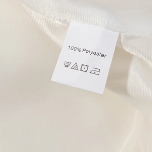 Close-up of garment label showing 100% polyester material and washing care instructions