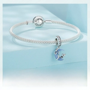 Detailed close-up of S925 sterling silver moon cat charm on a braided snake chain bracelet