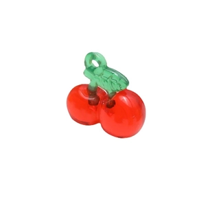 Red cherry resin pendant with green leaves for DIY jewelry making on white background