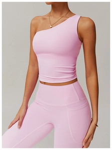 Detail of pink one-shoulder yoga vest and high-waisted leggings with side pockets