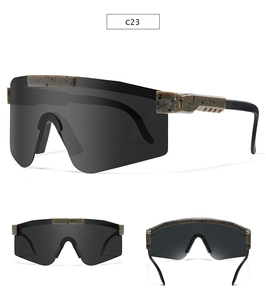 Detail view of large sports sunglasses with black lenses and brown speckled texture frames