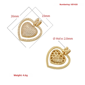 Macro detail of gold-plated heart pendant showing diamond pavé inlay and dimensions